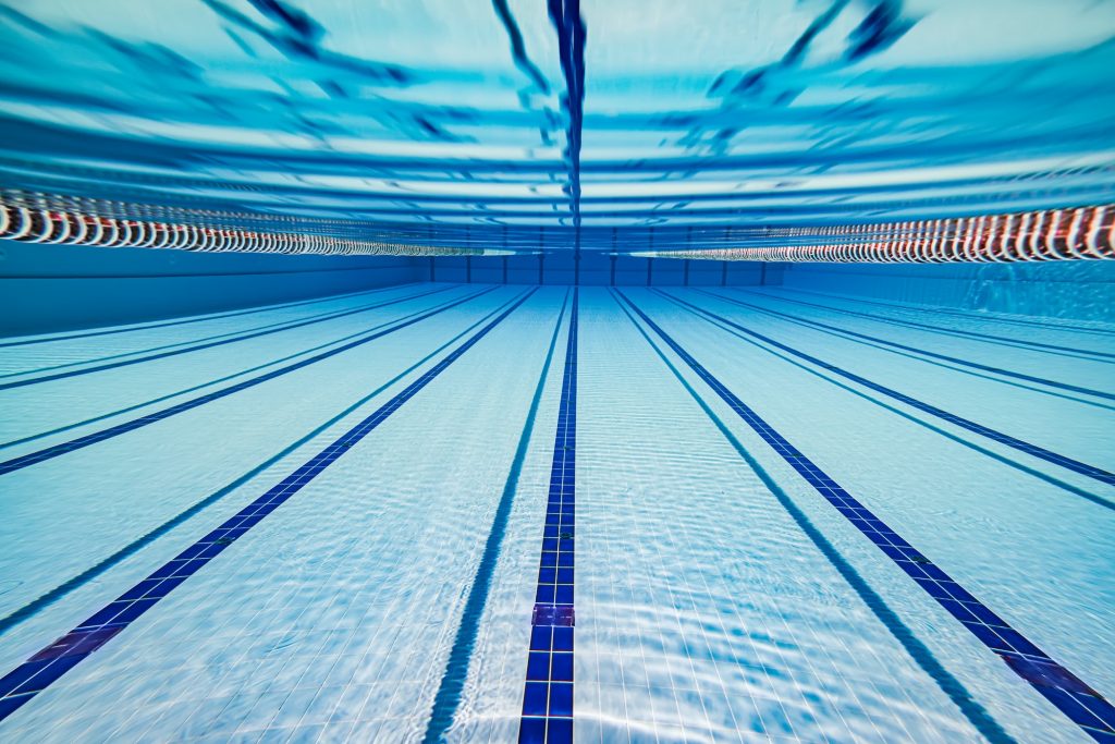 Olympic Swimming pool under water background.